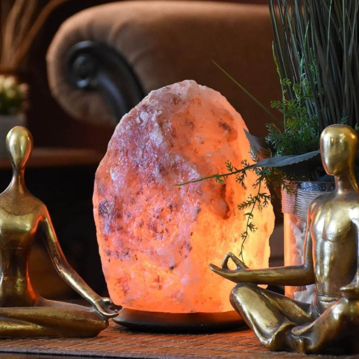 Hand-carved pink Himalayan salt lamp glowing on a wooden base